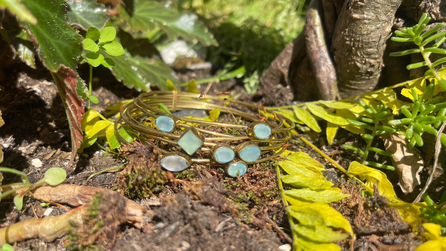Brass bangle with blue topaz